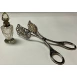 A pair of Continental white metal asparagus tongs; a silver mounted cut glass scent bottle, London