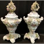 A pair of late 19th century Dresden type pedestal two handled vases and covers, each encrusted and