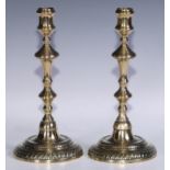A pair of George II/early George III brass candlesticks, of seamed construction, knopped pillars,