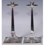 An Arts and Crafts style silver candlestick, dished circular drip pan, sreading square base with