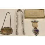 A pair of George III sugar bows; a silver bottle tag; an enamelled silver masonic medal (3)