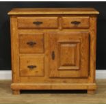 An oak side cabinet, rectangular top above an arrangement of drawers and a cupboard door enclosing a