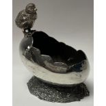 An E.P.B.M silver plated novelty spoon warmer, as a chick perched on the edge of an egg, 14cm high