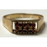 A 9ct gold eight stone ring, set with red stones, 3.6g