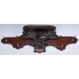 A softwood and mahogany wall mounted coat rack, carved in the Black Forest taste with an eagle, 81.