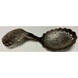 A Victorian silver sugar sifting spoon, pierced throughout, engraved and chased with flowers and