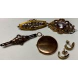 A Victorian diamond target brooch; a 9ct gold oval brooch, cast with flowering stems; another; a