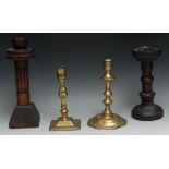 A George II brass petal base candlestick, of seamed construction, knopped stem, domed shaped