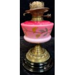 A 19th century oil lamp, Dietz Davis & Co., graduated pink milk glass font painted with flowers,