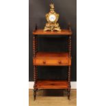 A Victorian rosewood three-tier whatnot, the central plateau with a frieze drawer, spirally turned