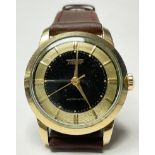 A Tissot automatic gentleman's wrist watch, black and gold dial, baton hour markers, leather strap