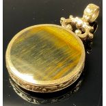 A gold coloured metal fob, inlaid with tiger eye and moss agate