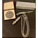 A medal commemorating the sinking of the Lusitania, boxed; a bosun's whistle, boxed; an ARP