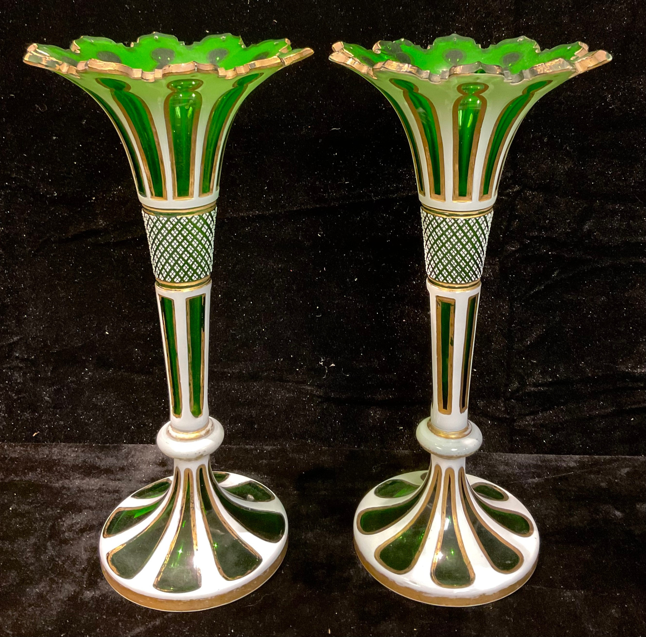 A pair of 19th century Bohemian green flashed glass trumpet vases, shaped cut rim, formerly lustres,