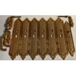 Interior Furnishings - a set of three gilt metal door plates, cast with trellis and flowerheads,