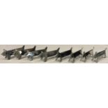 A set of eight Art Deco novelty knife rests, as stylised dogs, marked Inox, 8cm long