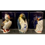 A Royal Crown Derby paperweight, Rockhopper Penguin, gold stopper, boxed; others, Penguin and Chick,