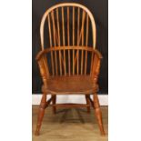 A beech and elm Windsor elbow chair, hoop back, one-piece mid-rail, turned arm posts, saddle seat,