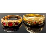 A 9ct gold three stone garnet ring, size R, marked 375, 2g; a gold plated dress ring, set with paste