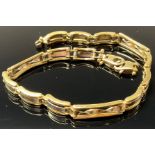 A 9ct white and yellow gold fancy link bracelet, marked 375, 20cm overall, 9.4g