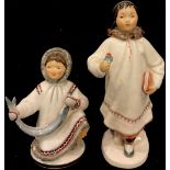 A pair of Russian Lomonosov porcelain Inuit figures, printed marks in red, the tallest 20.5cm