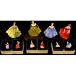 A Royal Doulton figure Winsome HN2220; three others, Alexandra HN2398, Nina HN2347, Geraldine