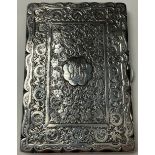 A Victorian silver rounded rectangular visiting card case, engraved with trailing ivy and