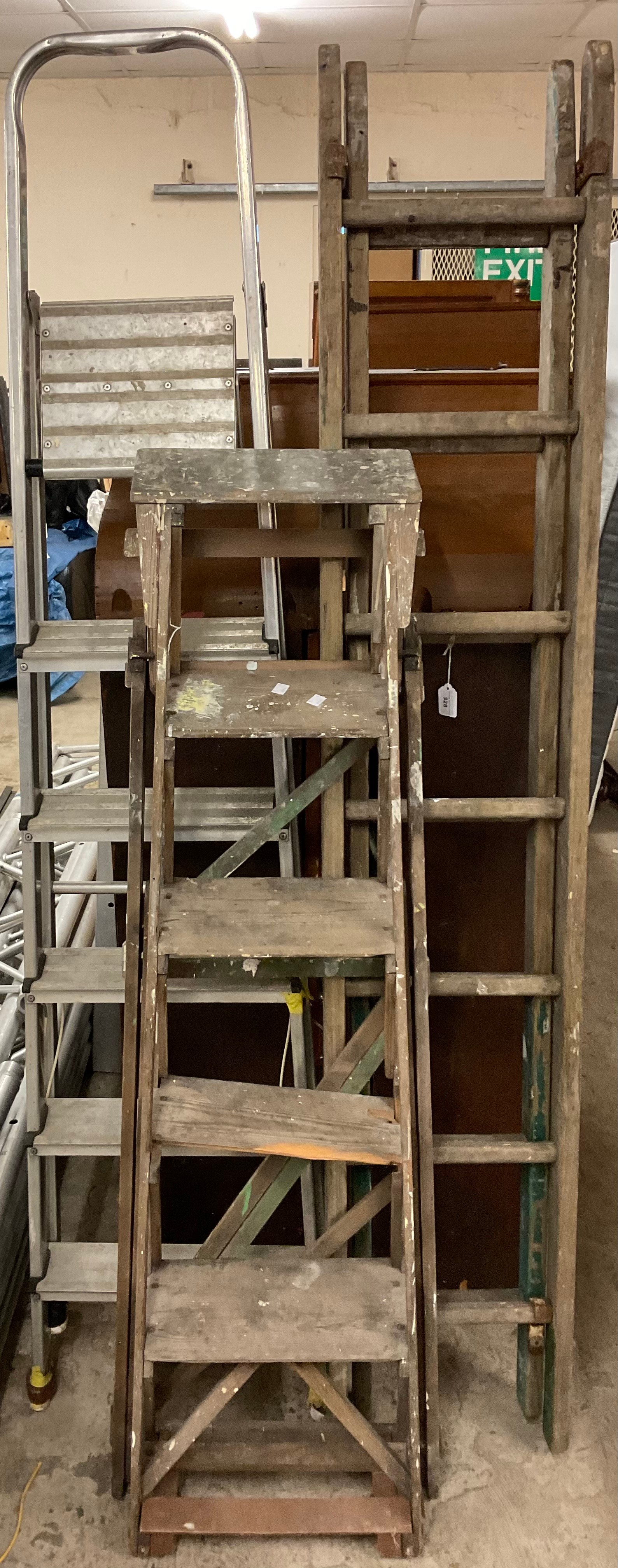 A set of metal step ladders; a set wooden step ladders; others