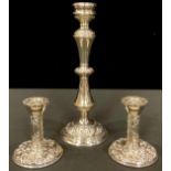 A pair of Elizabeth II silver boudoir candlesticks, Birmingham 1977; another silver candlestick,