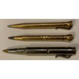 A 'trench art' pen, constructed from rifle shells; two gold plated pencils (3)