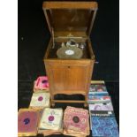 An Academy floor standing wind up gramophone, oak cased; a quantity of shellac 78rpm records, etc