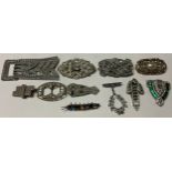 A collection of costume jewellery, brooches, belt buckles, etc