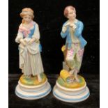 A pair of 19th century French bisque figures, of a young gentleman gardener and companion, 25cm high