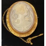 A 9ct gold shell cameo brooch, the border with rope twist, engraved and chased with scrolls