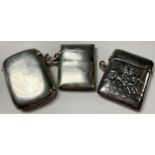 A sterling silver vesta case, repousse worked with a pair of racing jockeys on horse back,