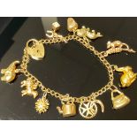 A 9ct gold curb link charm bracelet, including hedgehog, lion, rabbit, elephant, dice, acorn,