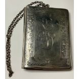 An early 20th century Egyptian revival sterling silver rounded rectangular purse, engine turned with