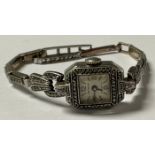 An Art Deco silver marcasite cocktail watch, square dial with Arabic and baton indicators,