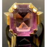 An 18ct and palladium gold ring, set with a single faceted amethyst, size O, marked 18CTPALL, 10.8g