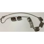 A pewter Scandinavian influenced necklace and clip earrings suite, decorated with Viking ships,