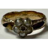 A 19th century unmarked gold mourning ring, set with a five stone seed pearl flowerhead, the