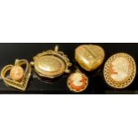 A 9ct gold oval swivel locket, marked 375, 3.8g; two 9ct gold mounted shell cameo pendants, each