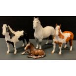 A Beswick model Pinto Pony, 1373, seconds version, Skewbald; another Piebald; others grey standing