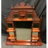 An Edwardian mahogany over mantle mirror, shaped stepped body with shelved front, inset with nine