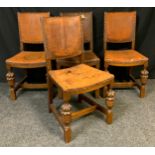 A set of four late Victorian oak chairs, tan leather upholstery to backs and seats, carved front