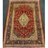 A Central Persian Kashan carpet / rug, knotted in tones of red, pale blue, and deep indigo, 285cm