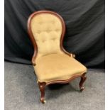 A Victorian mahogany button back nursing chair, upholstered in coffee brown, shaped fore legs,