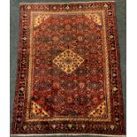 A North-West Persian Malayer or Malayir rug / carpet, knotted in tones of deep red, blue, black, and