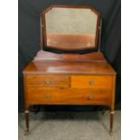 An Edwardian mahogany dressing table, shaped beveled mirror, turned reeded supports, pair of short