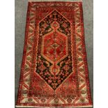 A North-West Persian Zanjan rug / carpet, knotted in tones of deep red, black, and pale grey,